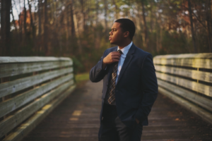 African American man in suit on a bridge